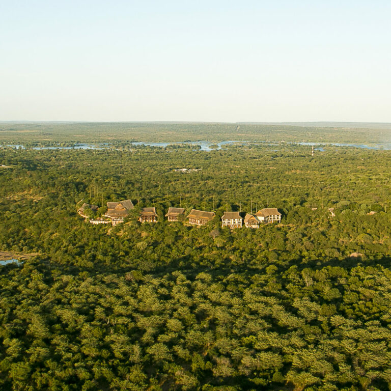 Aerial view of Victoria Falls Safari Lodge above the Zambezi treeline